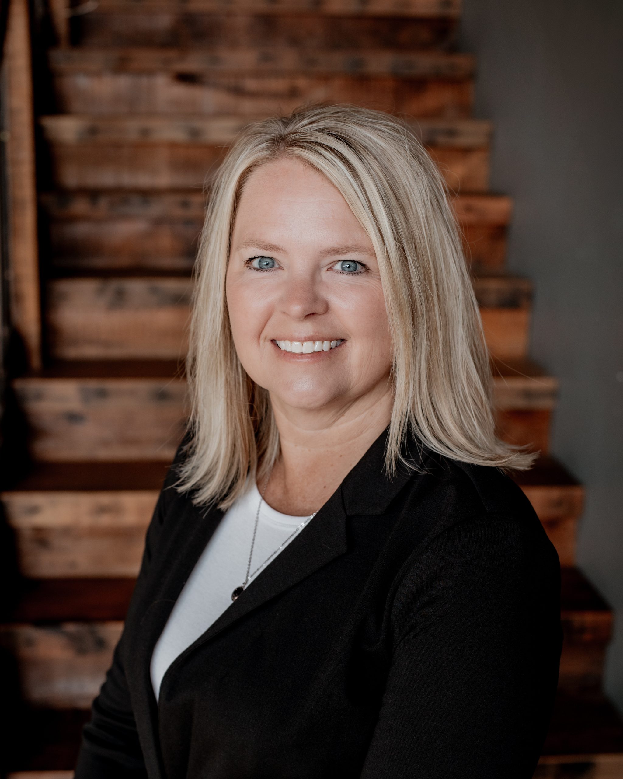 Professional headshot of Stephanie Sigmon wearing a black blazer and white top.